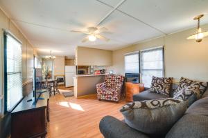 a living room with a couch and a kitchen at Waterloo Home Walk to Pickwick Lake Fishing Pier! in Waterloo