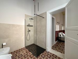 a bathroom with a shower and a toilet at Maison Ines Luxury B&B in Messina +41 photos
