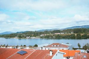 a view of a river with houses and mountains at Férias em Cerveira in Vila Nova de Cerveira +12 photos