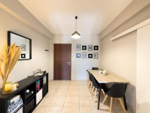 a dining room with a table and chairs at Thanos' seaside apartment in Oropos