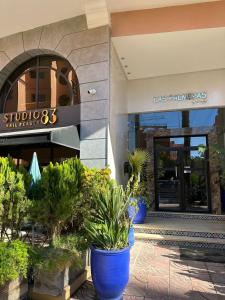 a store front with blue potted plants in front of it at new and modern apartment in Marrakech