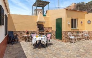 a patio with a table and chairs and a building at CASA CANDILES in Torrox Costa