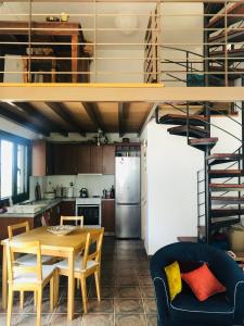 a kitchen and dining room with a table and chairs at Jennie's lovely countryhouse - Malakontas Eretria in Malakóndas