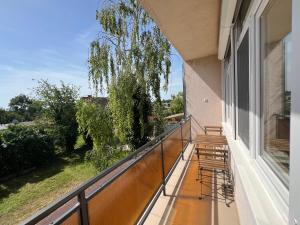 a balcony with chairs and a view of a yard at Jó hely in Balatonalmádi