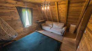 a living room with a couch in a log cabin at Sweet Home Zabljak in Žabljak
