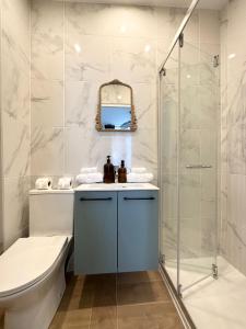 a bathroom with a toilet and a shower at Villa Jade Etretat in Étretat