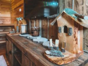 a wooden counter top with a bird house on it at Sweet Home Zabljak in Žabljak