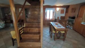 a kitchen and dining room with a table and a staircase at Gran Severino in Fabbrica Curone
