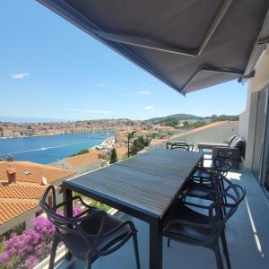 a table and chairs on a balcony with a view at Design penthouse 5 in Mali Lošinj