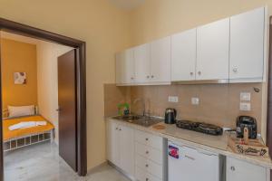 a kitchen with white cabinets and a counter top at Le petit Paris in Panagia +7 photos
