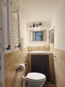 a bathroom with a toilet and a sink at Il Pianerottolo in Manziana +40 photos