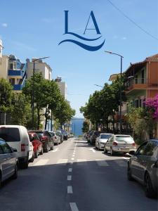 a street with cars parked on the side of the road at LA Comfy AP in Sarandë