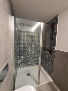 a bathroom with a shower with a glass door at B&Bi13 in Magenta +18 photos