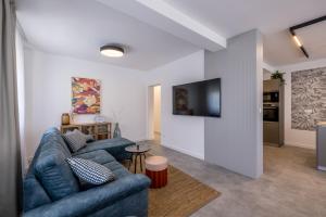 a living room with a couch and a tv at Rosemary 4M in Ražanj