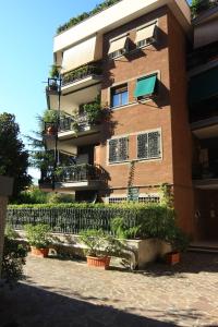 a building with potted plants in front of it at B&B Viale Dei Colli Portuensi 589 in Rome