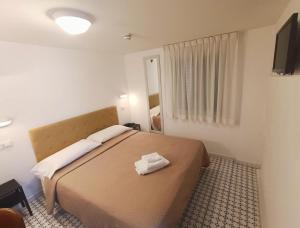 A bed or beds in a room at Hotel Le Terrazze