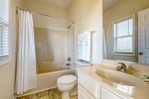 a bathroom with a toilet and a sink and a tub at Just Breathe #4-RR in Rodanthe +22 photos