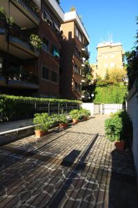 a sidewalk in front of a building with potted plants at B&B Viale Dei Colli Portuensi 589 in Rome