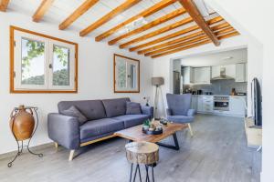 a living room with a couch and a table at Solea Cottage - Bright Escape in Skopelos in Skopelos Town +25 photos