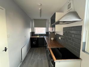 a kitchen with a sink and a counter top at Berridge House in Nottingham