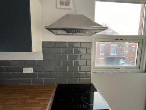 a stove top oven in a kitchen with a window at Berridge House in Nottingham +4 photos