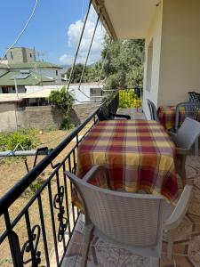a patio with a table and chairs on a balcony at Ari's Guest House in Borsh +5 photos