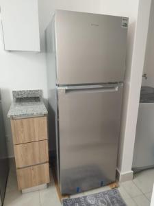 a stainless steel refrigerator in a kitchen next to a counter at santiago de los caballeros hipanoamericana in Santiago de los Caballeros