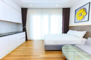 a hotel room with a bed and a couch at TMS-PULLMAN MINH MINH Apartment in Quy Nhon