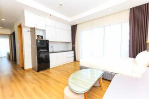 a kitchen and a living room with a table at TMS-PULLMAN MINH MINH Apartment in Quy Nhon