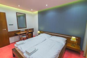 Posteľ alebo postele v izbe v ubytovaní Hotel Arkada