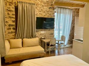 a living room with a couch and a table at Artemis all seasons in Elliniko