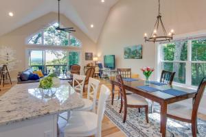 a dining room and living room with a table and chairs at Modern Hendersonville Home Deck and Mountain Views! in Hendersonville