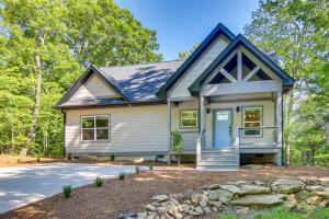 a small white house with a blue door at Modern Hendersonville Home Deck and Mountain Views! in Hendersonville