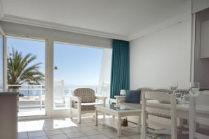 a living room with a view of the ocean at Acapulco Ocean View in San Agustin
