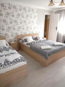 a bedroom with two beds and a wall at Miramar in Łeba