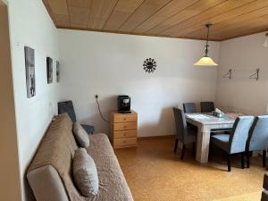 a living room with a couch and a table at Tabita 1 Apartment with 3 rooms if needed 4 or 5 rooms in Untermeitingen