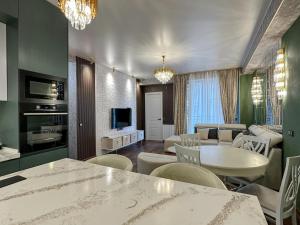 a living room with a couch and a table at Downtown Residence in Tbilisi City