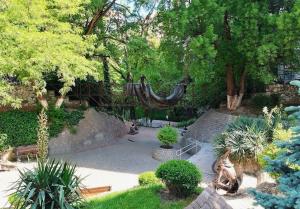 a garden with trees and stairs in a park at Downtown Residence in Tbilisi City
