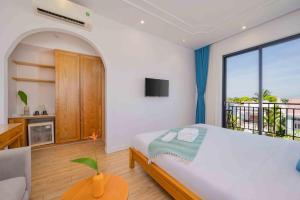 Postel nebo postele na pokoji v ubytování Lime Villa Hoi An + 32 fotografií
