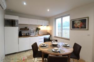 a kitchen and dining room with a table and chairs at Les Gites de Mael et Rose in Plougasnou