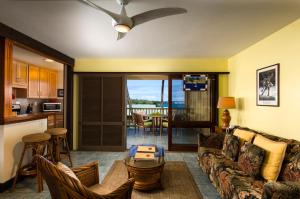 a living room with a couch and a table at Hana Kai Maui - #104 Haneoʻo in Hana