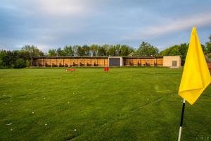 a yellow flag in a field with a building at Mercure Newcastle George Washington Hotel Golf & Spa in Newcastle upon Tyne