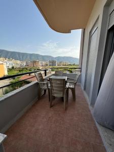 a patio with a table and chairs on a balcony at AJ Apartments in Orikum