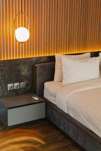a bedroom with a bed and a table with a lamp at Deluxe apartments Canggu area with gym coworking security parking and full services in Tumbak Bayuh +27 photos