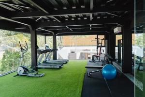 a gym with several treadmills and exercise machines at Deluxe apartments Canggu area with gym coworking security parking and full services in Tumbak Bayuh