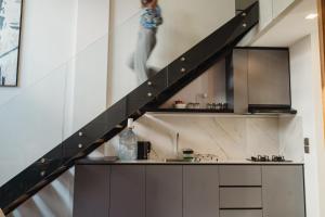 a staircase leading up to a kitchen in a house at Deluxe apartments Canggu area with gym coworking security parking and full services in Tumbak Bayuh