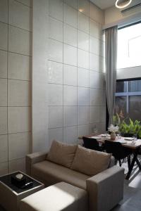 a living room with a couch and a table at Deluxe apartments Canggu area with gym coworking security parking and full services in Tumbak Bayuh