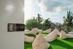 a bunch of pillows sitting on the grass at Deluxe apartments Canggu area with gym coworking security parking and full services in Tumbak Bayuh