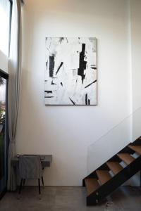 a room with a painting on the wall and a table at Deluxe apartments Canggu area with gym coworking security parking and full services in Tumbak Bayuh