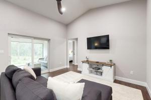 a living room with a couch and a flat screen tv at Royal Highlands Retreat in Weeki Wachee